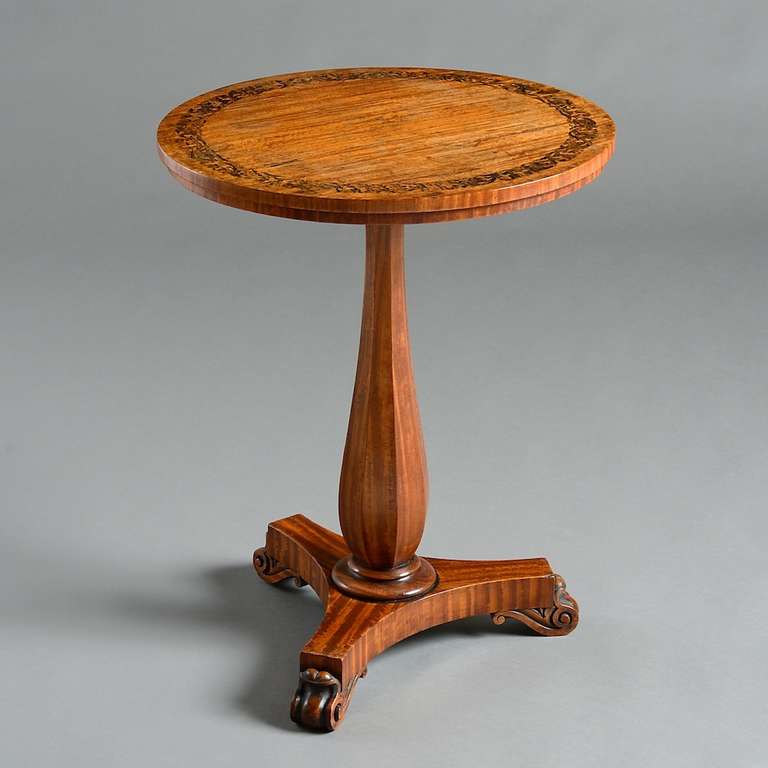 an early Victorian satinwood lamp table inlaid with scrolling foliate coromandel marquetry, circa 1840.