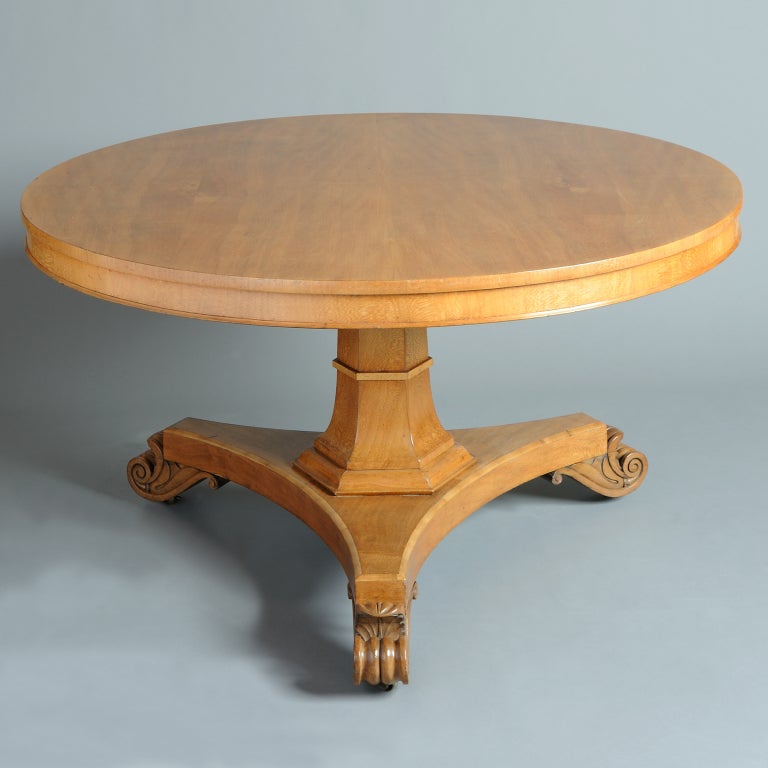 A William IV lacewood centre table with circular tilt-top and concave base with lotus scroll feet, circa 1830.