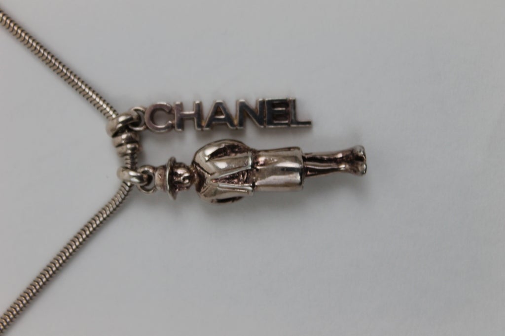 This is a whimsical piece by Chanel created in sterling silver; marked 925. The pendant measures 1 1/4 inches high and the chain is 16 1/2 inches long.