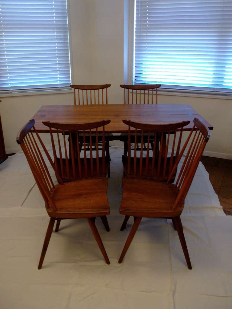 George Nakashima dining table, walnut top with rosewood butterfly joints over four tapered legs with cross-stretcher, two 14