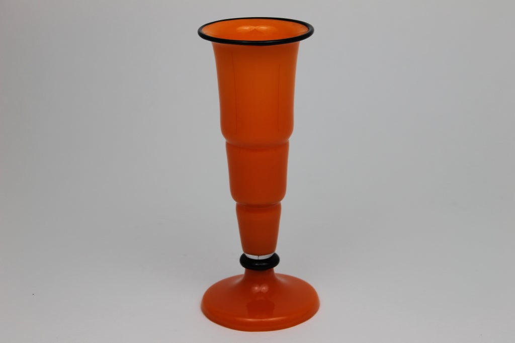 Beautiful Czech glass vase in vibrant orange with black lip and band.