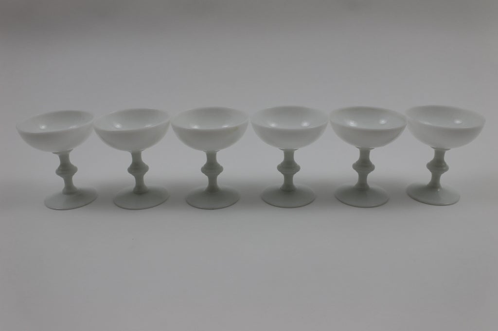 Coupes in hand blown white milk glass. These have no seams and vary slightly in size because they are individually hand blown. There are 6 water goblets also available.
