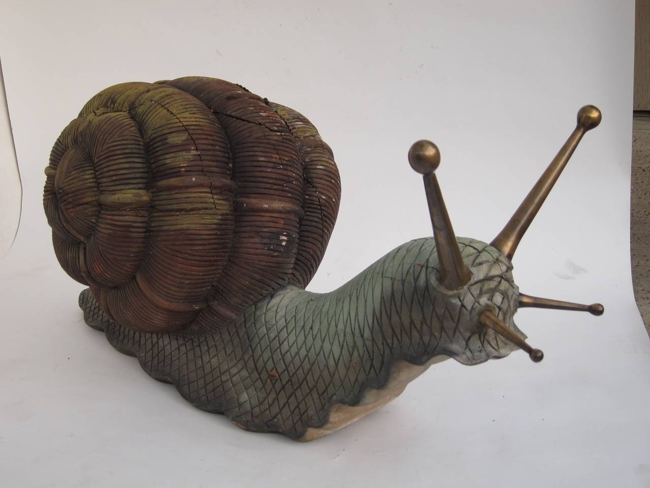 Giant hand-carved wood and brass snail sculpture.