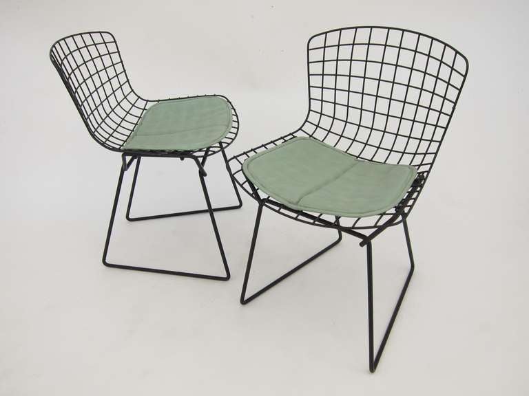 Pair of kid's Bertoia wire chairs with original paint and teal vinyl cushions.
