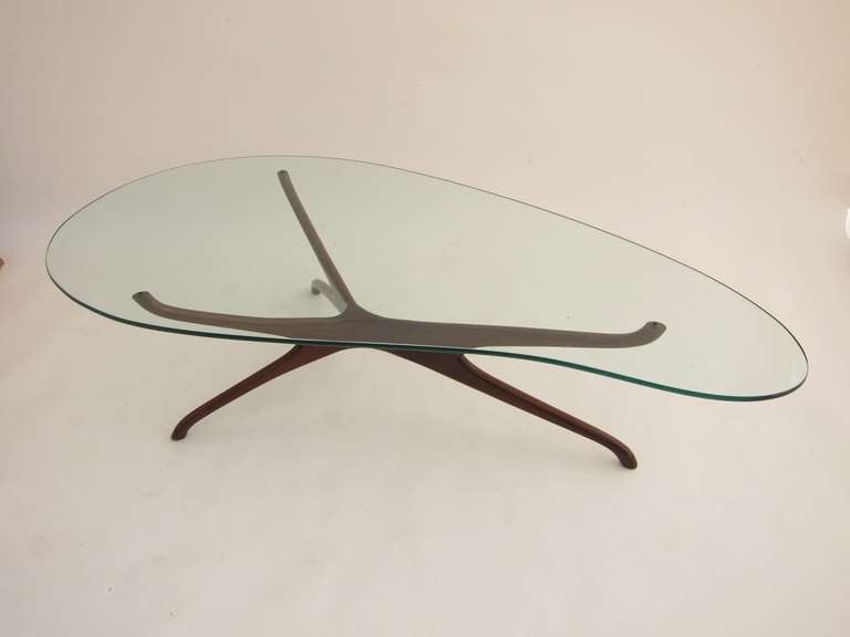 Classic tri-symmetric coffee table by Vladimir Kagan in dark walnut, with kidney-shaped glass.