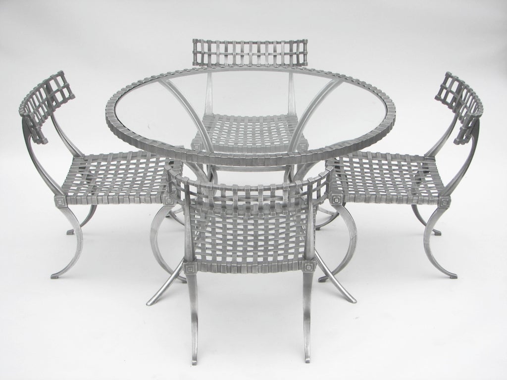 Cast aluminum Patio Set by Thinline of California. In the style of T.H. Robsjohn-Gibbings Klismos chairs. New glass. Polished aluminum.