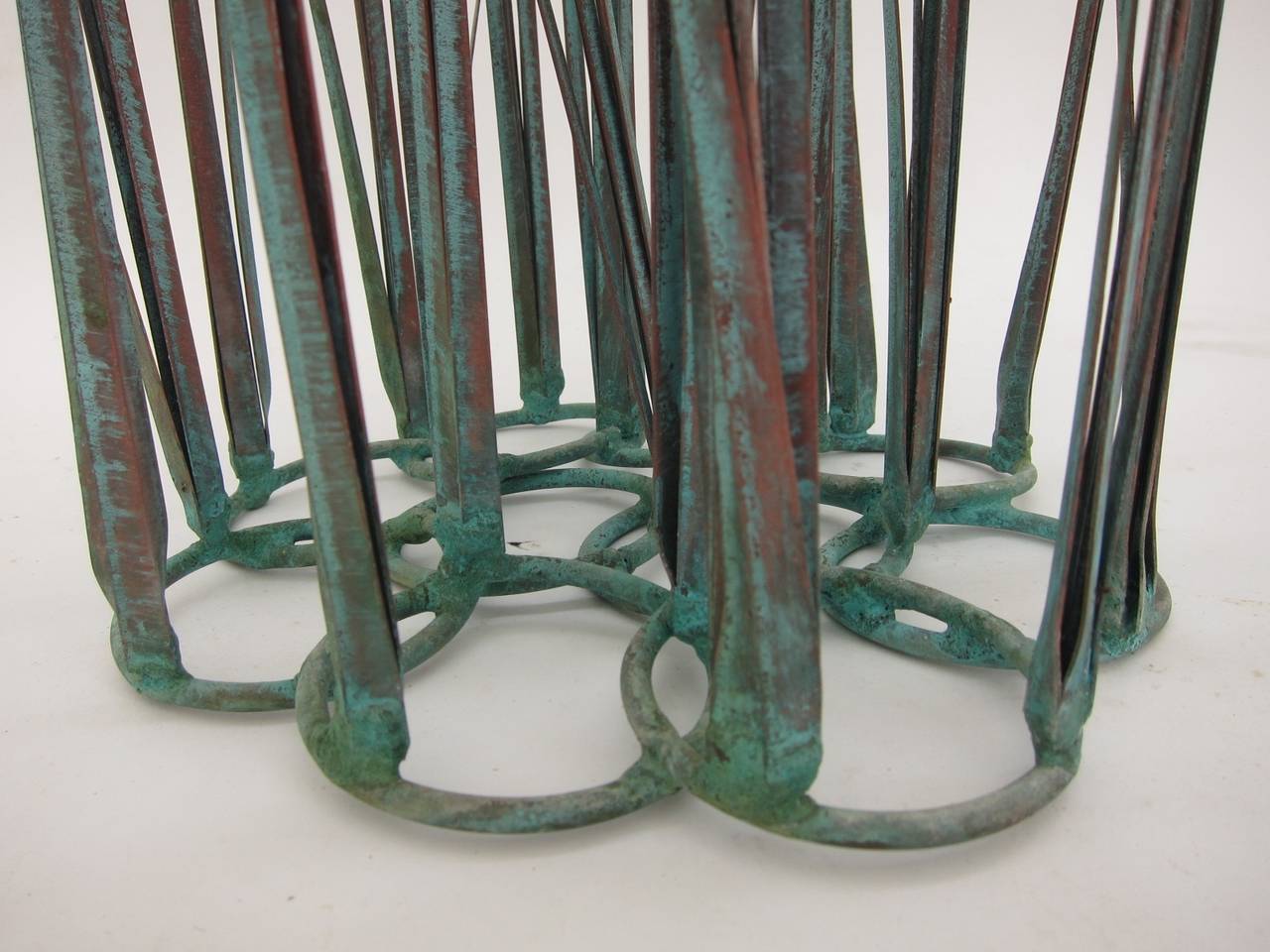 Copper cattail sculpture with natural patina.