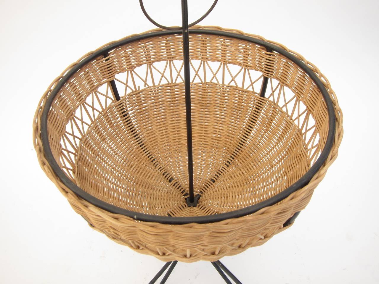 Mid century catch-all. Iron frame with wicker basket.