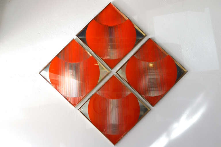 Retro 1970s mirror op art/ decorative wall hangings. The work features a silk-screened gradient abstract pattern in atomic orange. Looks stunning in an office or modern home. 

This 4 piece design is composed of individually aluminum silver framed