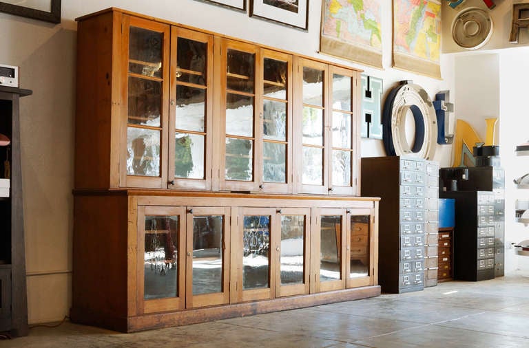This is a large solid softwood step back display cabinet, circa 1890-1910. A stunning American arts and crafts/ craftsman style piece from the physics lab at California's historic Stanford University. 

The stacked 2 piece cabinet is composed of 6