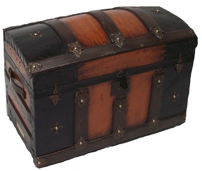 Compact sized camel-back antique trunk. Reddish-brown tint with multiple coats of tung oil. 

All original hardware. Lined with black velvet cotton. 
30lbs.

Restored by renowned Randall Barbera Antique Trunk Restoration and Design, Manhattan