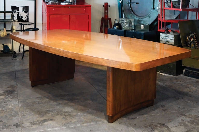 This stunning Stow Davis conference table in high-gloss lacquered walnut is rare and unique. Features a thick, apron-cut table top resting on curved plinths. Streamline and sleek.