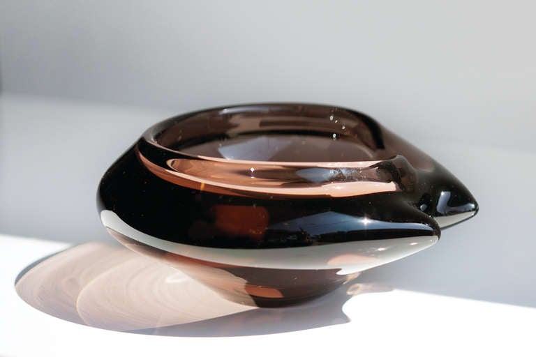 1950s thick glass ashtray in a stunning modernist form. This is piece is most likely Murano glass, though it may be Scandinavian glass or of another very high artisan quality. Whatever it's origin, it is quite simply gorgeous.