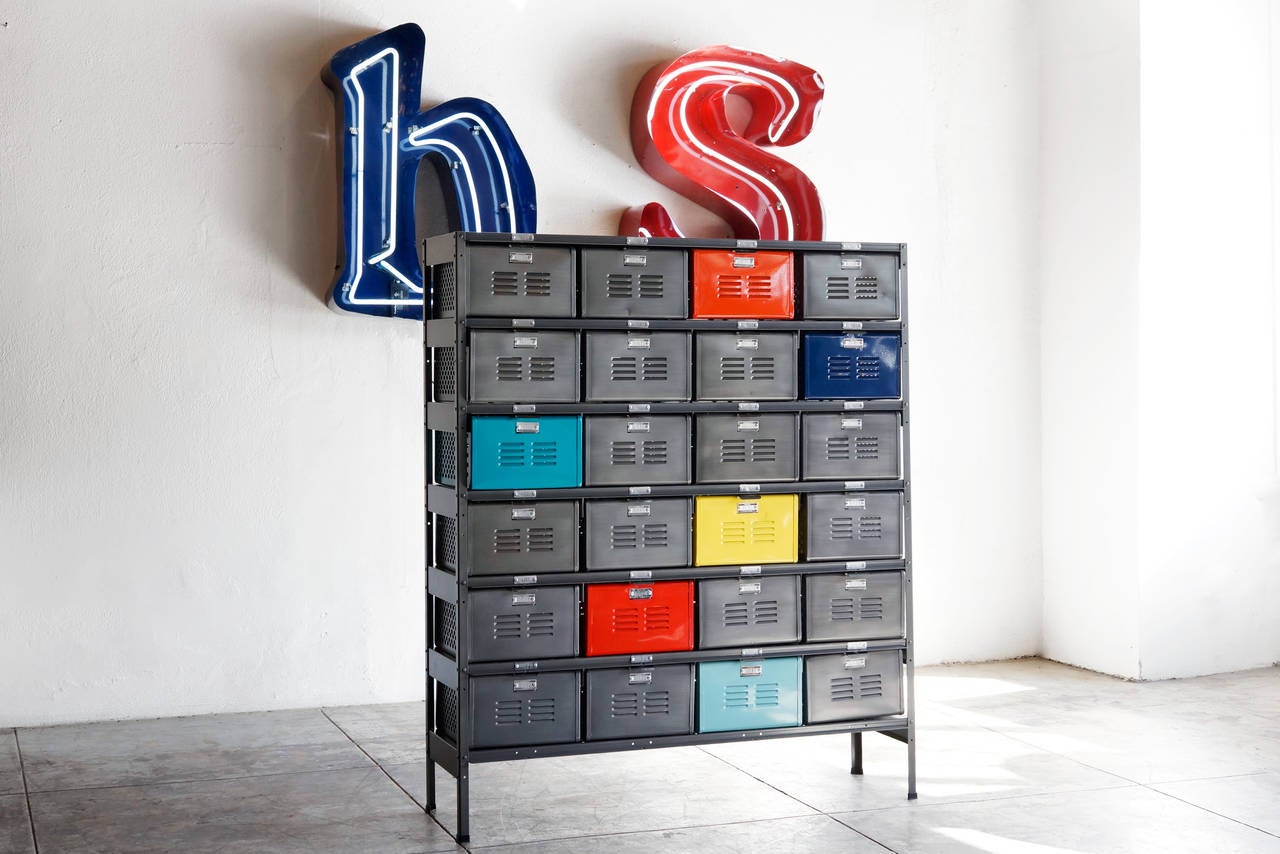 Our vintage locker basket units are composed of midcentury, all-American locker bins in a vintage steel frame, with a refinished powder-coat. Featured here is a 4 x 6 unit with multicolored baskets in a natural steel frame. All original hardware.