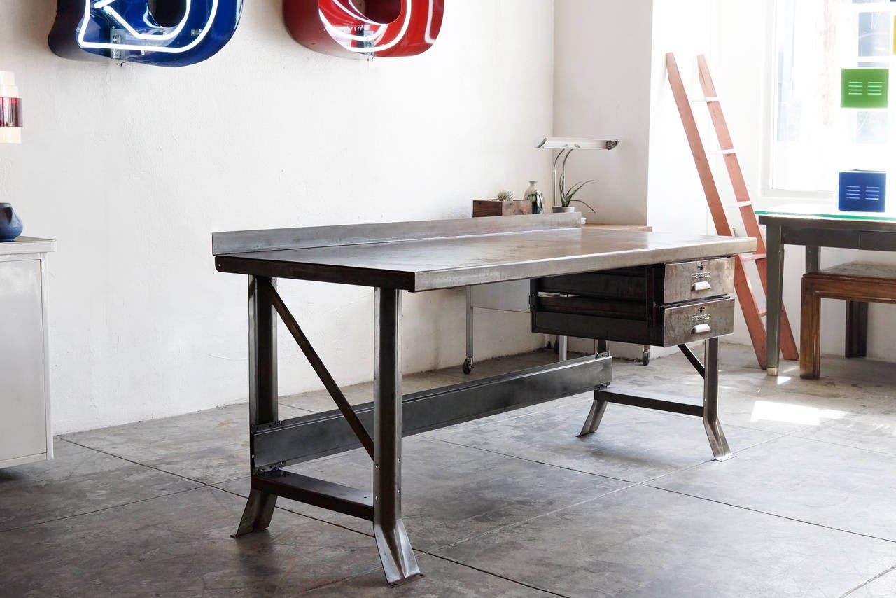 1940s Pressweld workbench with two drawers. All steel. Heavy duty, industrial construction. Great patina, sealed with a light clear coat. 

Dimensions: 29