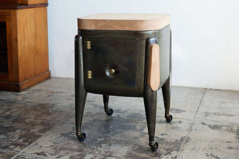 This gorgeous machine age, early model Maytag washing machine has been repurposed by a contemporary artist and furniture-maker. The body is stripped and treated, bringing out a unique, iridescent patina to the steel. The top is replaced with