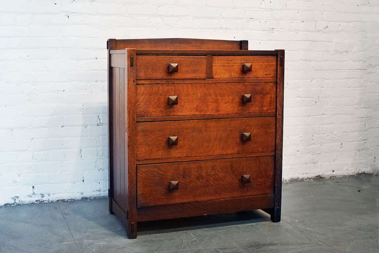 Gustav Stickley arts & crafts chest of drawers/ dresser, c. 1901. Inverted v-back with two drawers over four drawers, chamfered sides, original finish with original pointcut wood pulls. Authentic with original signature on top left-hand drawer.
