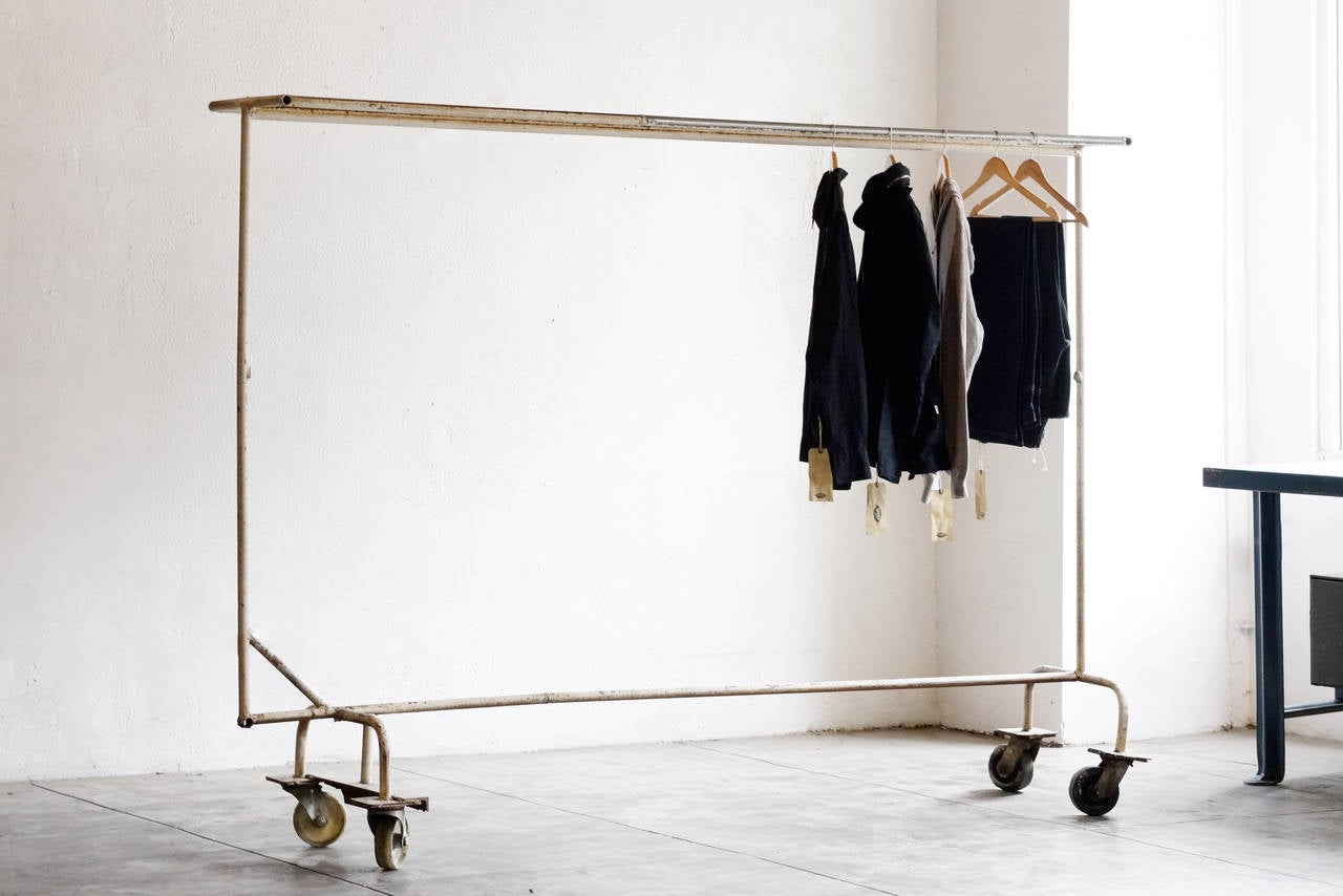 Industrial steel mobile garment rack, c. 1950s. Unusual extra large size. Rolls on heavy duty vintage casters. Outstanding vintage patina. 

Dimensions: 21