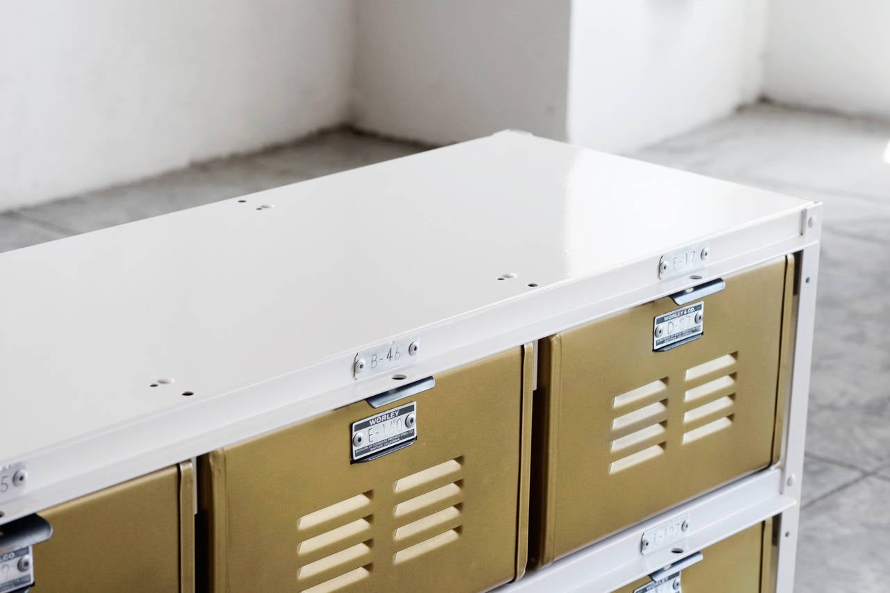 Our vintage locker basket units are composed of mid-century, all-American locker bins in a vintage steel frame, with a refinished powder-coat. Featured here is a 4 x 2 unit with Sun Gold baskets in a White frame. All original hardware.