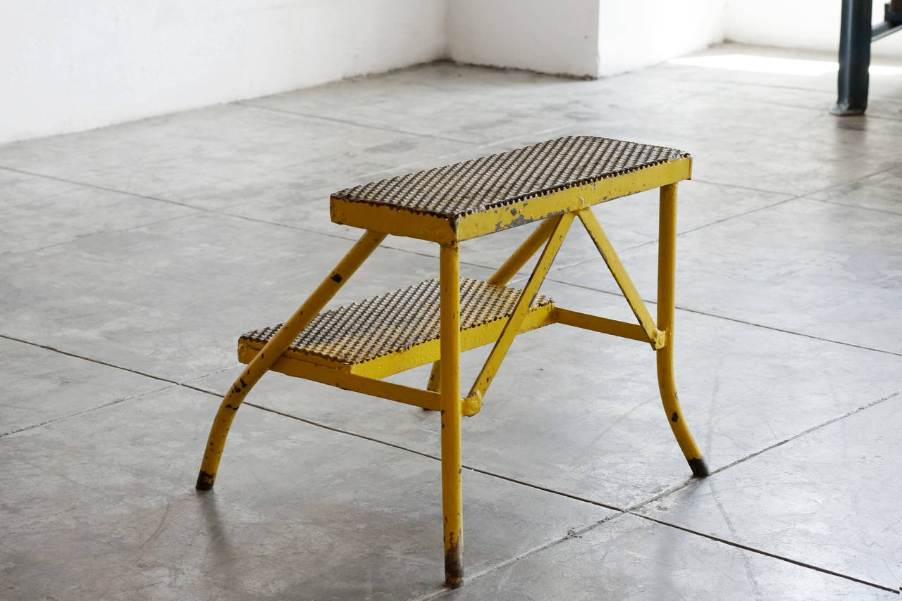 Vintage industrial stool with  perforated metal tred steps. Heavy duty construction. Original yellow paint shows unique patina.  

3 available. Sold separately. 

Dimensions:  22.5