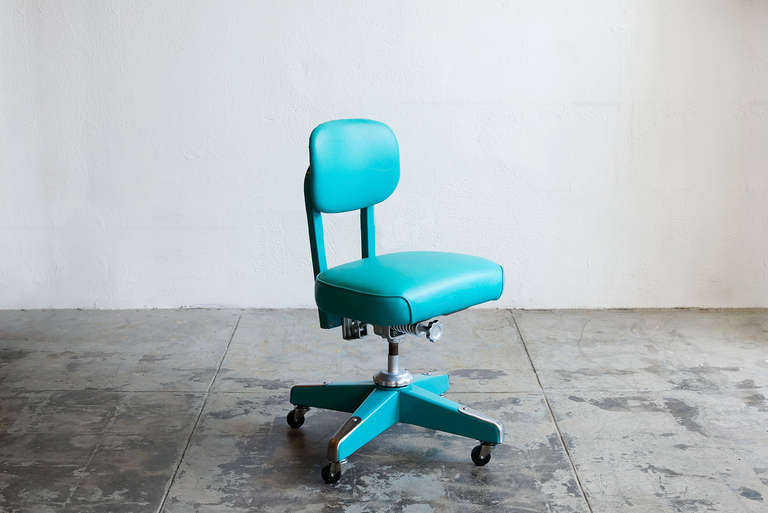 This classic 1950's steno chair is newly refinished in turquoise on turquoise frame and seat. Features original, iconic hardware- industrial adjustment knobs and chrome toe caps.

Adjusts, swivels, and rolls on casters.

Please see our second