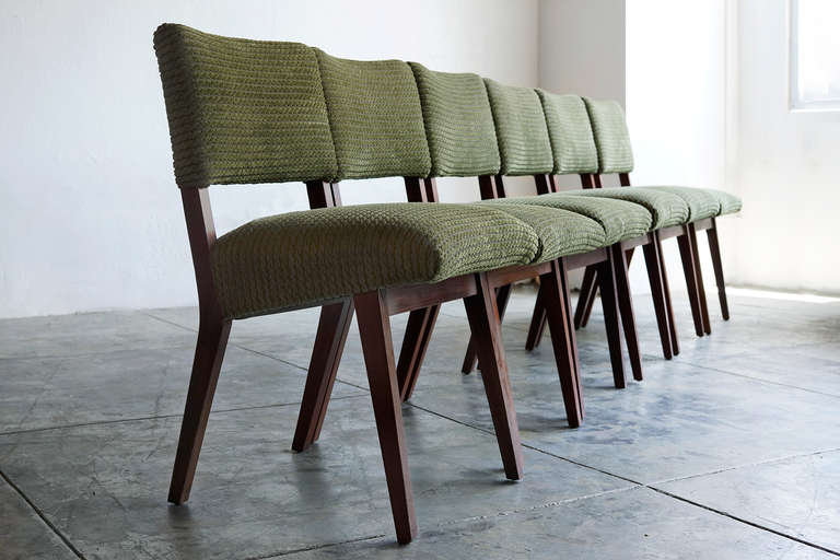 This great-looking set of mid century dining chairs features modern walnut frames and new upholstery in moss-green chenille. In the style of (or quite possibly by) Heywood-Wakefield. Iconic lines and angles.