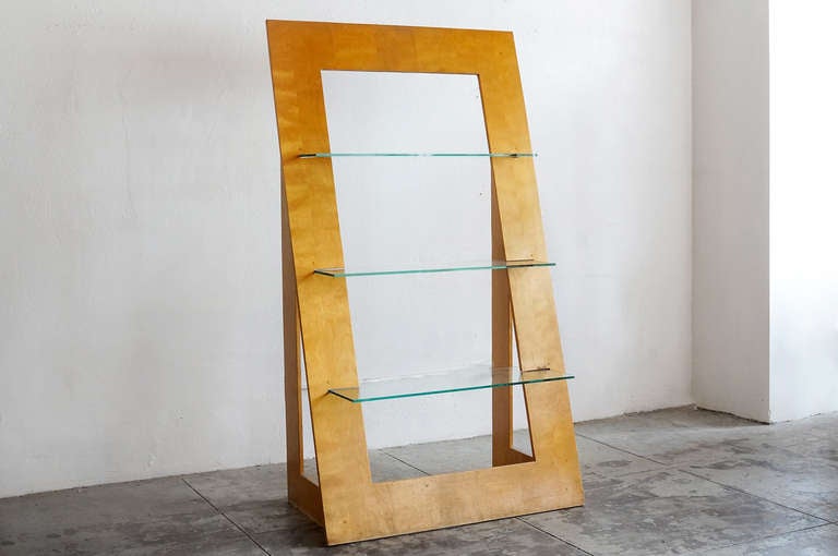 This 1970s vintage wood and glass-shelved bookcase in a triangular shape is modern and unique. Makes an instant statement piece. Glass shelves are in excellent condition; birch ply is gently worn.