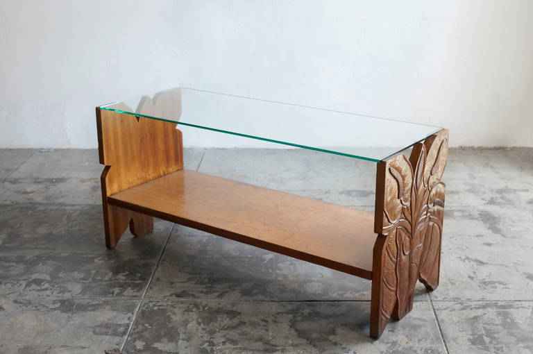 This beautifully hand-carved mango wood coffee table featuring Hawaii's Anthurium plant, was sold by the legendary Gumps Department Store of Waikiki in the 1930s. The elegant two-tier shelf design is especially suitable for display of books or
