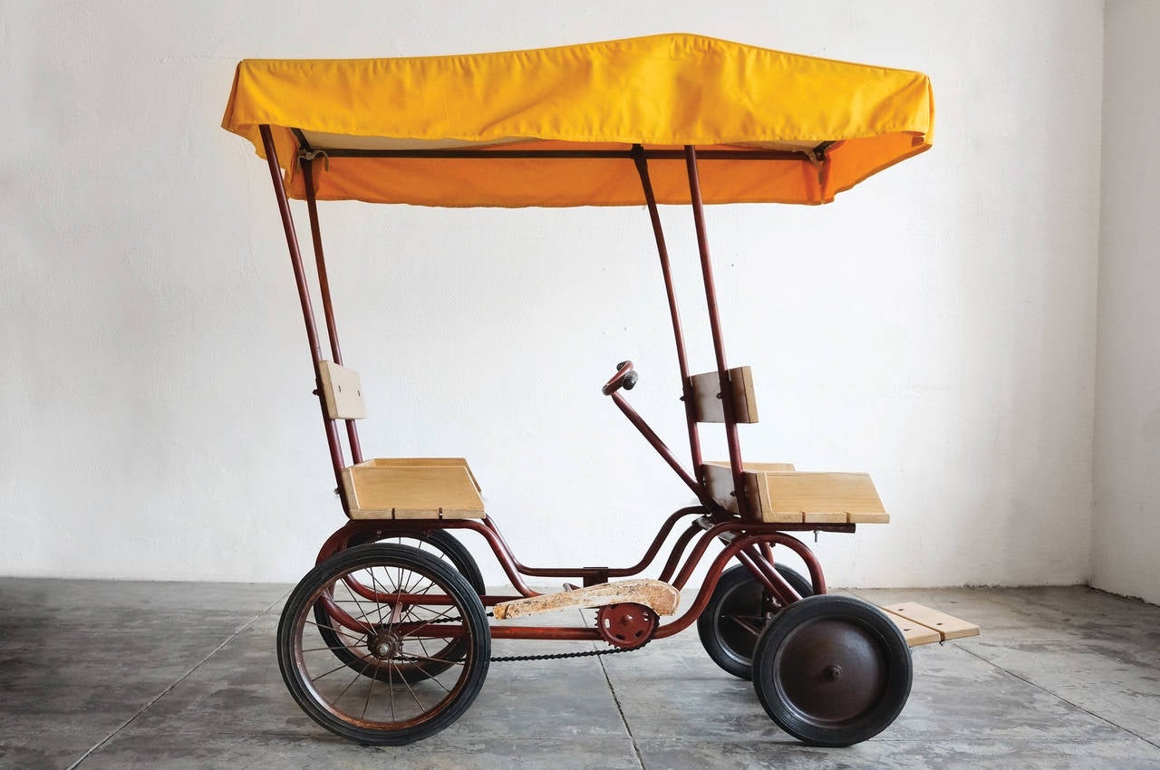 Classic Americana pedal car. Wonderful vintage patina. Original frame with rebuilt wood driver and passenger seat as well as canvas awning based images of the original.