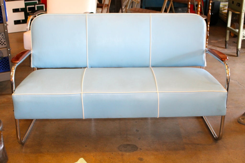 Vintage mid-century chrome tube sofa reupholstered with baby blue marine vinyl with white welt. Chrome finish polished to it's original luster. Sleek wooden arms with walnut finish. Great inside or out!