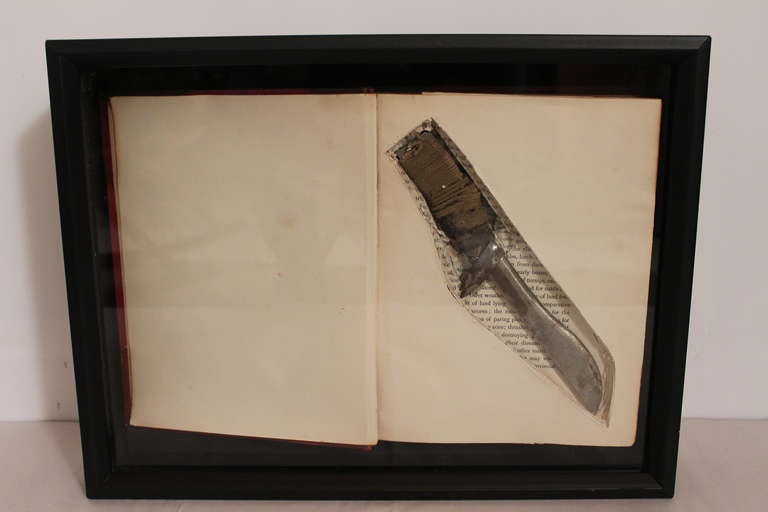 This handmade knife hidden in a book came from a collection of confiscated items from the warden of a New Jersey prison.
It was acquired mounted in this shadow box.
A chilling and graphic object.