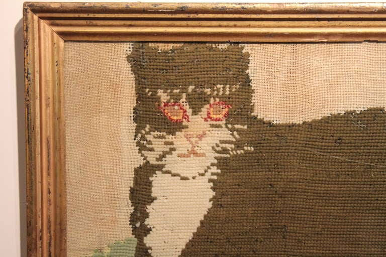 Graphic primitive needlework cat with a gilt frame from the 19th century.