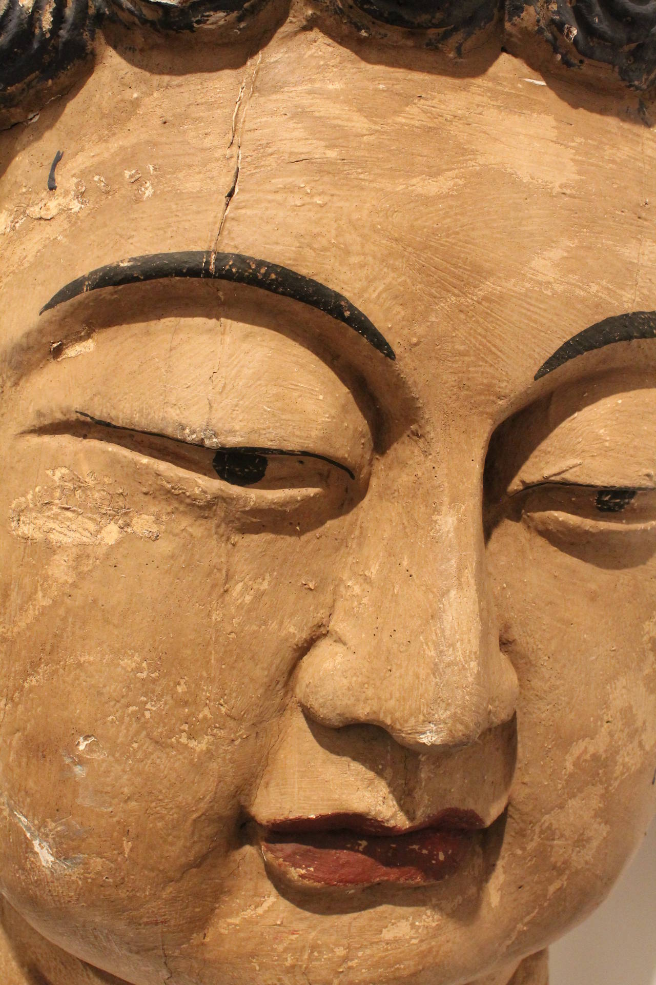 Hand carved from a single piece of wood this buddha head is over 3 ft. tall.