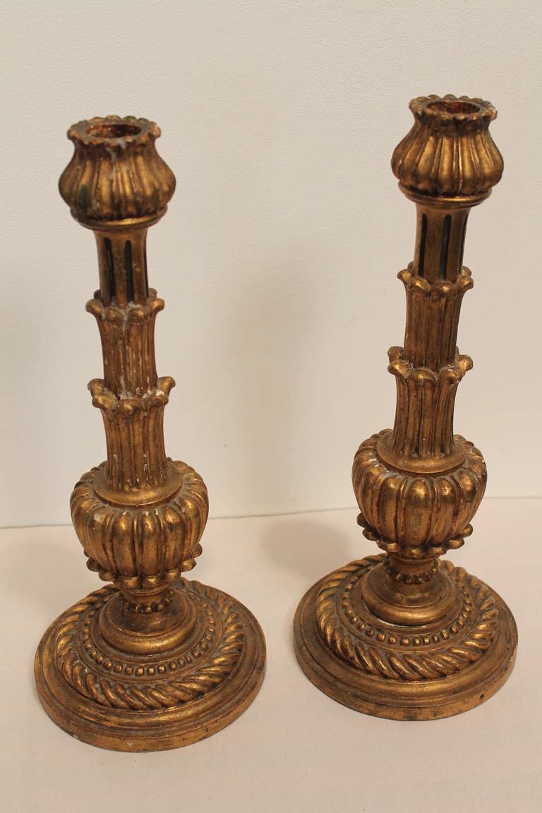 Great form and detail in this pair of hand carved and gilt candle stands. Stamped 