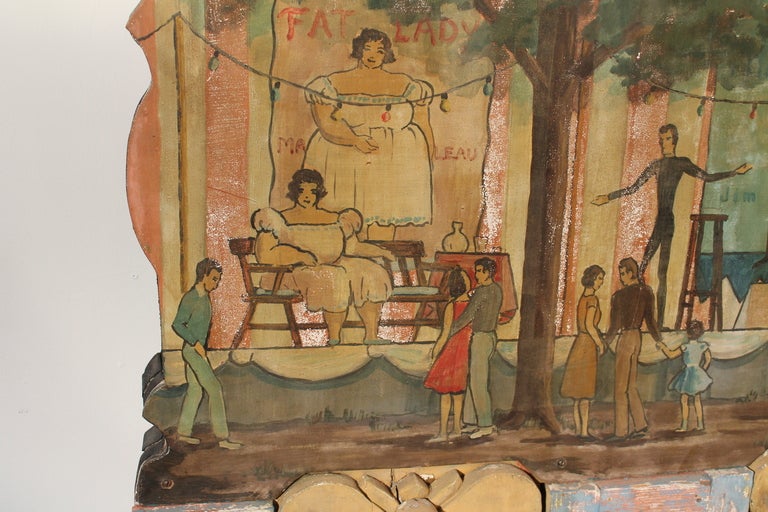 This fragment is from a carousel and features hand painted freak show characters , including images of the fat lady , the skinny man , the bearded lady , the strong man , and finally the tattooed lady.
The piece includes 8 of the original lighting
