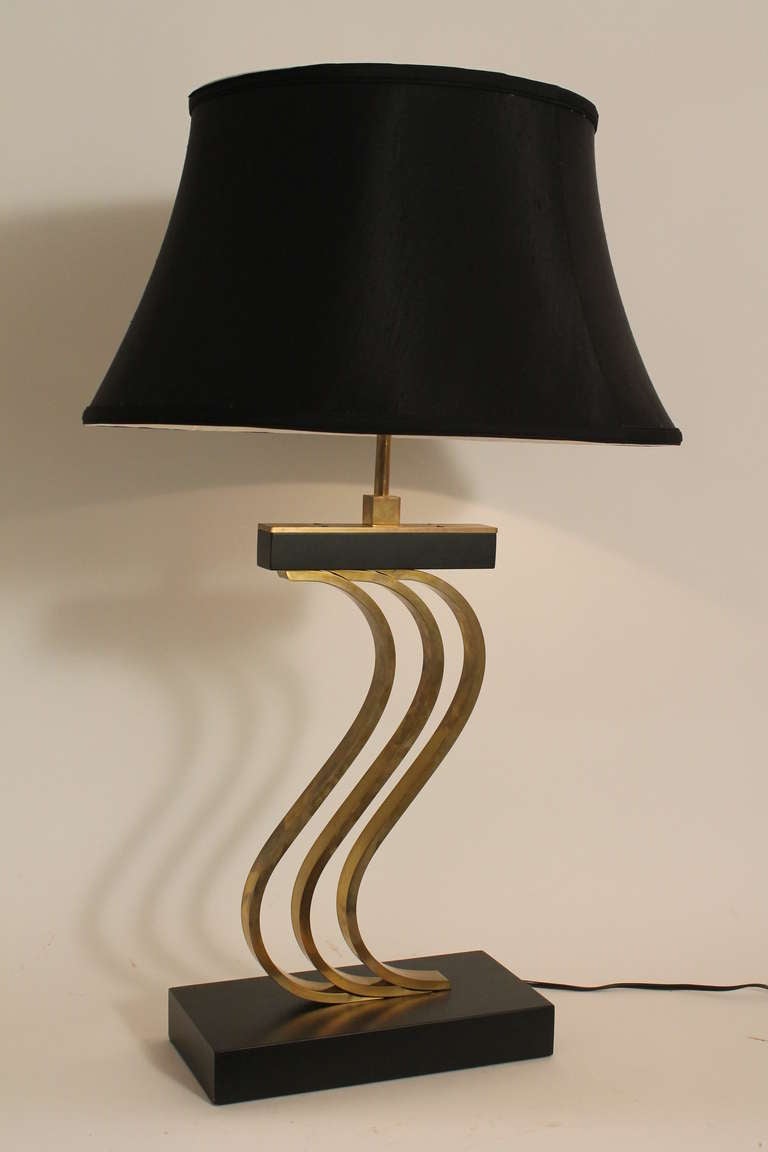 Sculptural 1950's brass and ebonized wood table lamp manufactured by the Majestic Lamp Co.
New 19