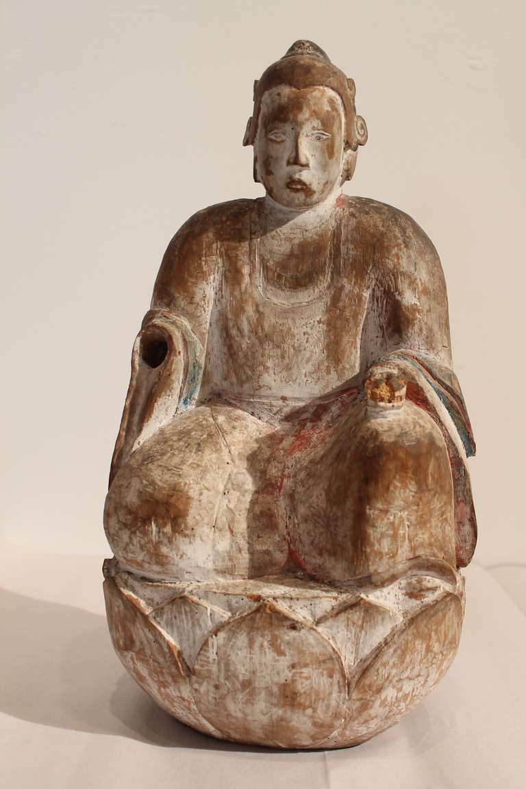 Fantastic tranquil buddha carved on a lotus with remnants of original paint.
Great detail in the carving of the face and the cloth of the robe.
Right hand missing and left hand damaged as seen in photos.
Strong and serene presence.
19th century