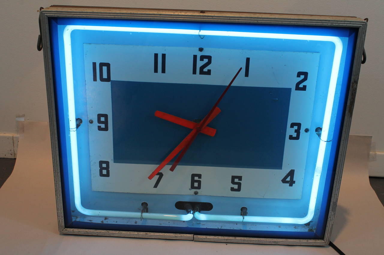 1950s functional clock from a diner with a neon perimeter.
There is a handle on the back and the hooks on each side so that it can be hung.