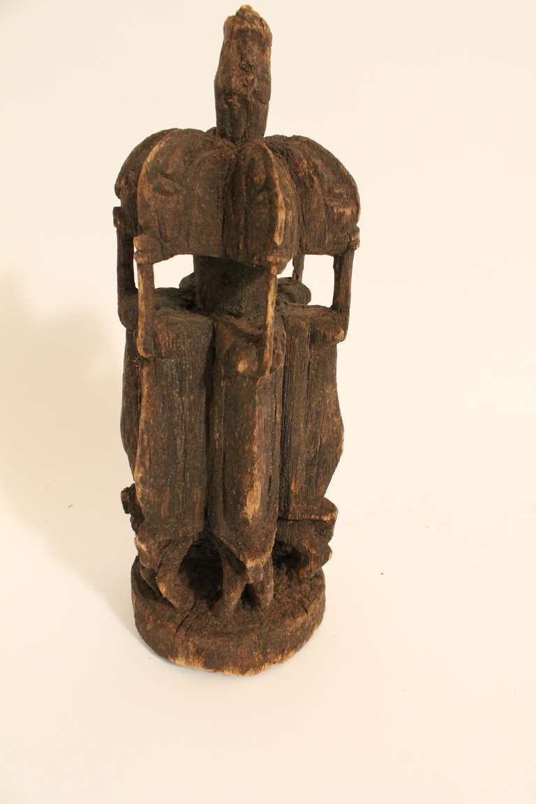 Wonderfully worn carved group of 6 figures surrounding a central staff , used by a Dogon shaman in healing rituals.
