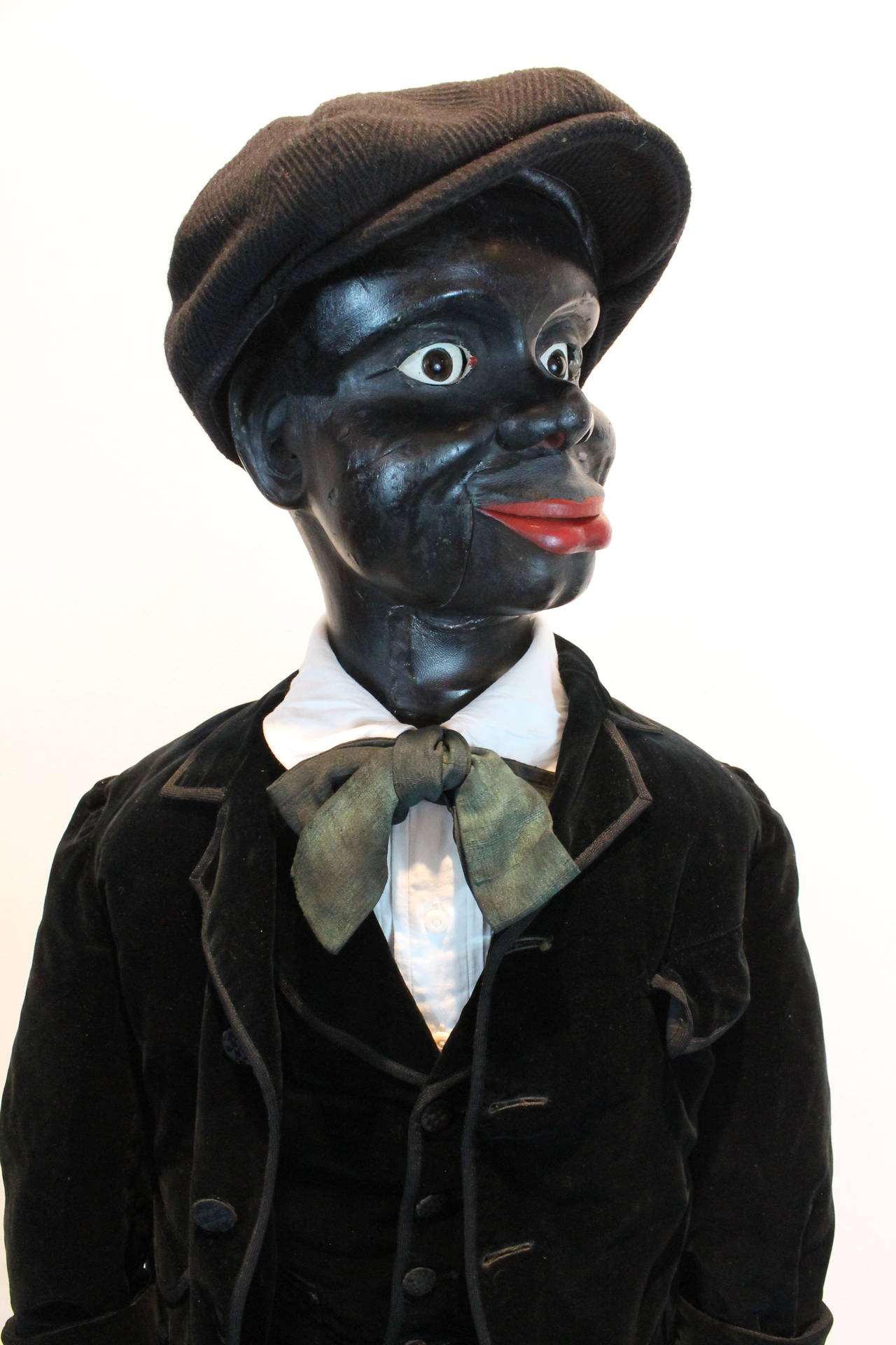Wonderful dapper ventriloquist dummy with a very expressive carved wooden face. The head rotates, the jaw and upper lip are controlled separately. The glass eyes also move. The upper lip is leather.
The hands are carved wood with a section of the