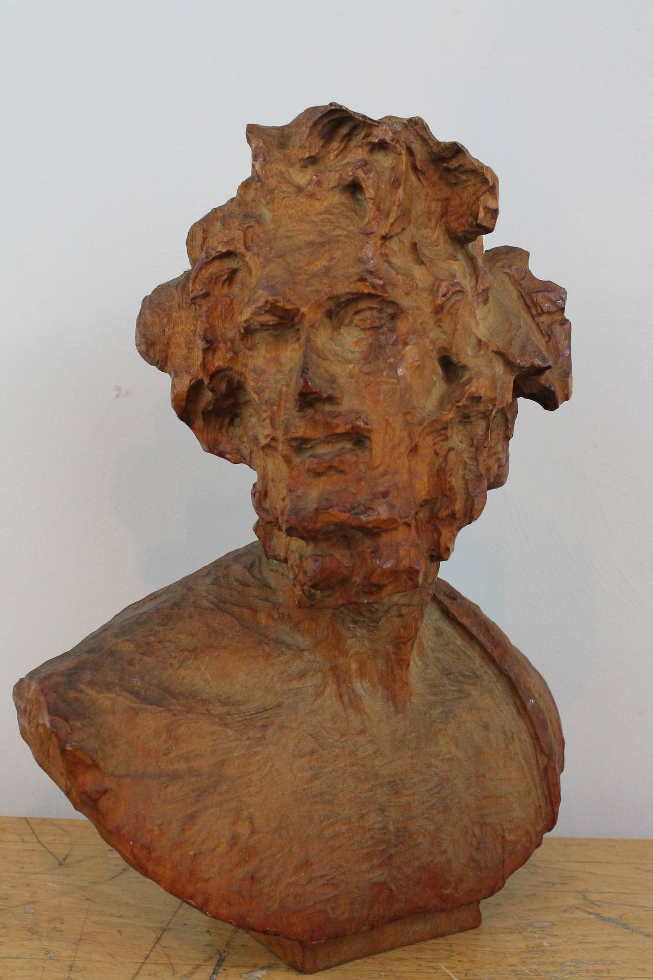 Exuberant energetically carved 19th Century wood bust of a man with wild hair and a great presence.