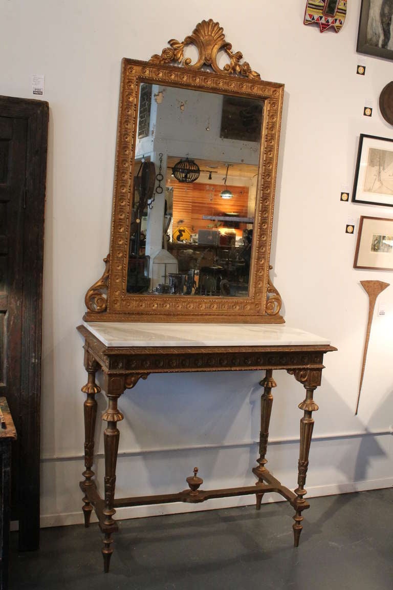 Wonderfully detailed carved and gilt 19th Century Italian console and mirror. Marble top over a faux marble painted console top.
The mirror is physically separate from the console.  