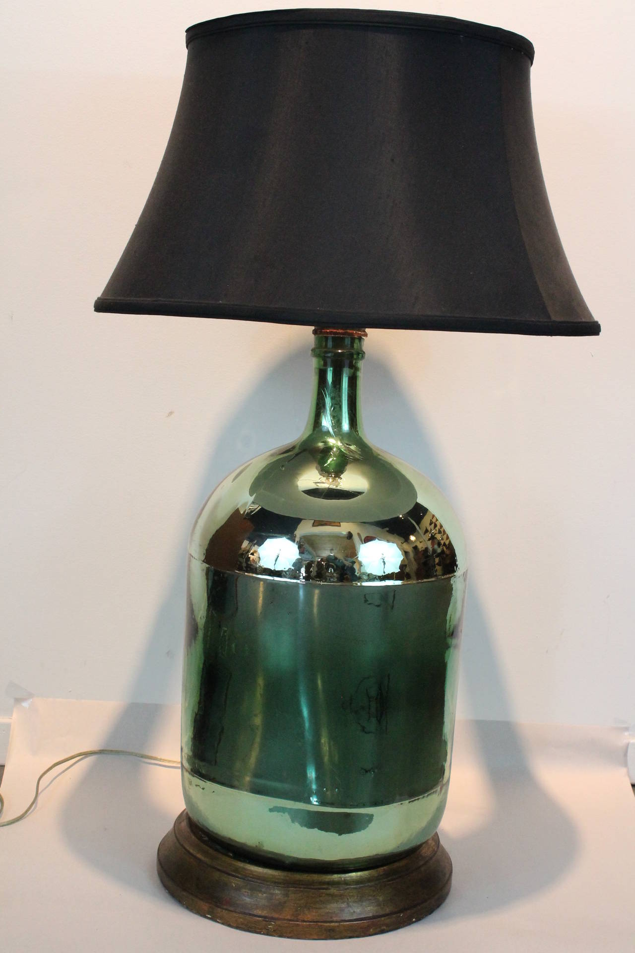 Early 20th century handblown green mercury glass vessel turned into a lamp.
On a turned giltwood base.
Lamp shade not included.