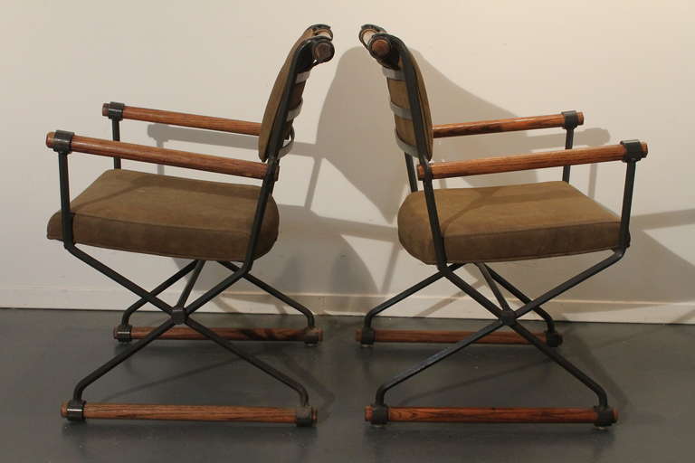 Pair of iron and oak doweled Cleo Baldon style campaign chairs upholstered in suede.
Very sturdy chairs, excellent from every angle.