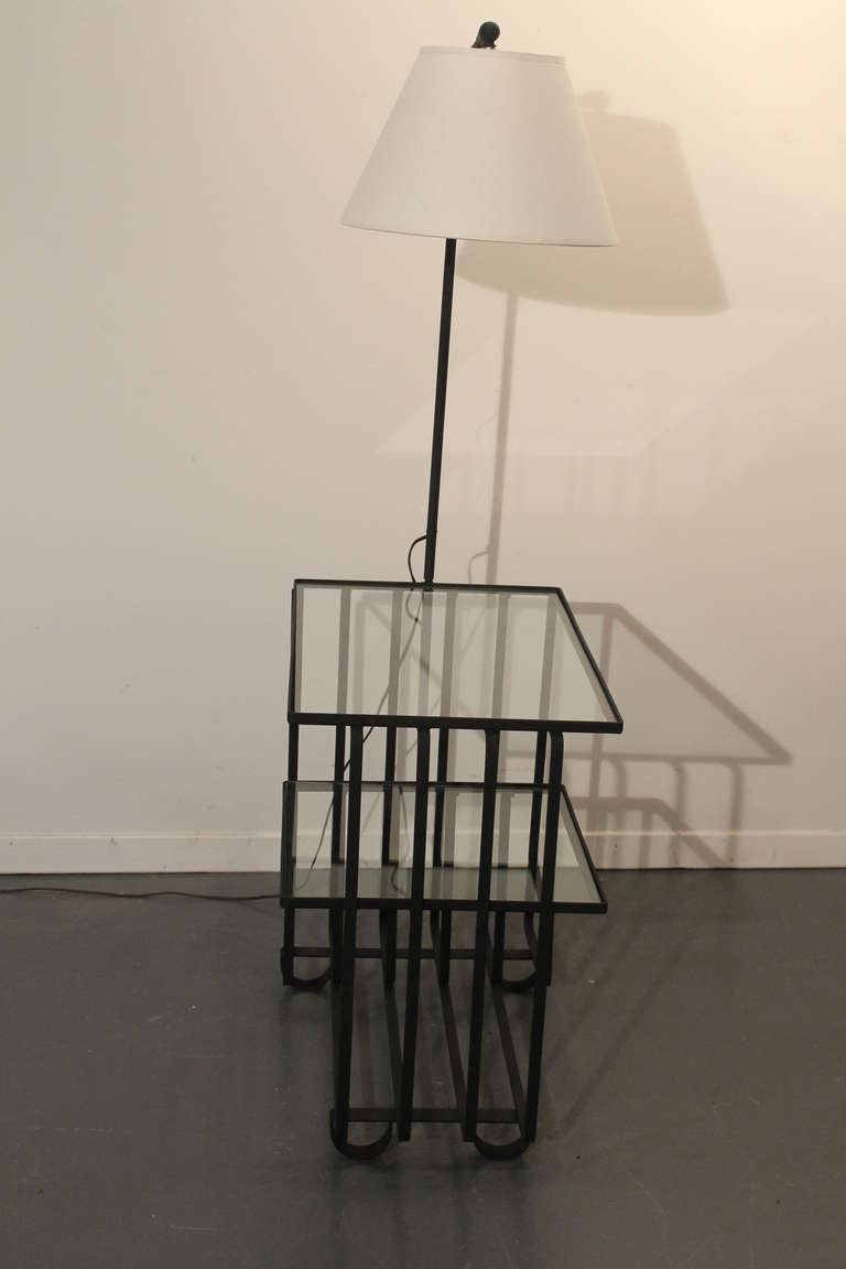 Great design and strong line and form on this iron and glass 2 tiered side table floor lamp.
New glass and shade.