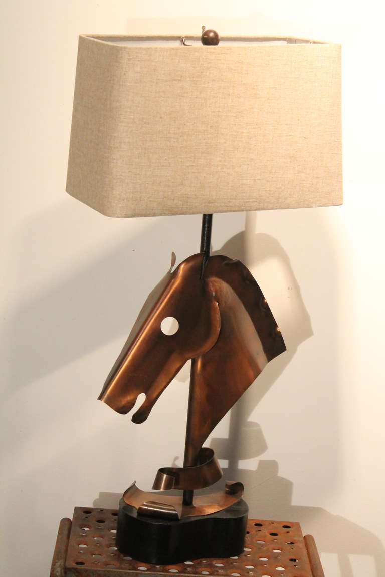 Modernist hand hammered copper horse head lamp by Heifetz. 
Large scale and fantastic form in excellent condition.
The lamp is stamped on the back of the ebonized amoeba form base.