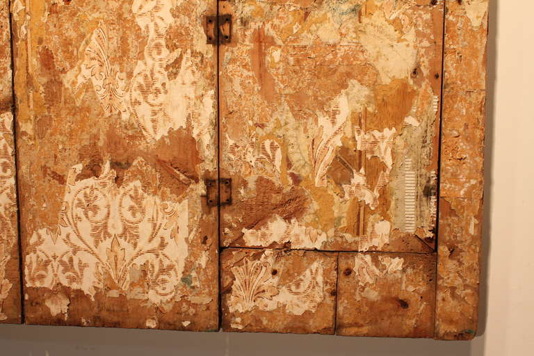 Ingenious construction of salvaged wall remnants converted into a fireboard.
Shows layer upon layer of early wallpaper.
Fantastic primitive folk art object with a very powerful Modernist presence.
The depth of surface and subtlety of color and