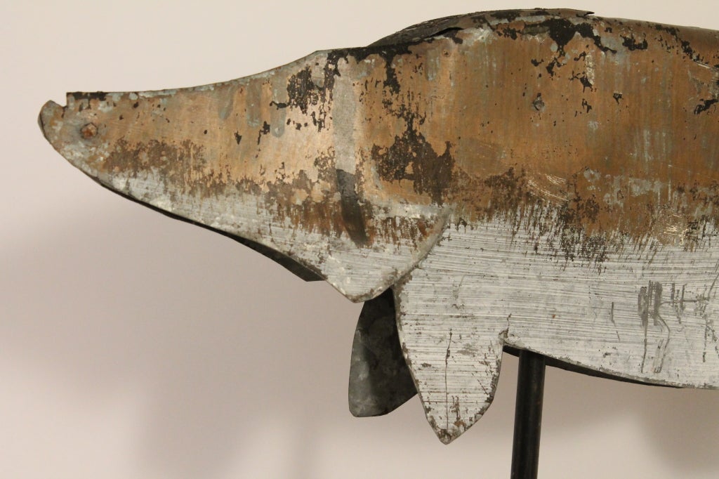 This wonderful weathervane has incredible surface paint and a real striking sculptural presence.
It originates from an Upper Penninsula Michigan fishing camp.
It is constructed of a single sheet of painted tin that was bent and forms a hollow body.