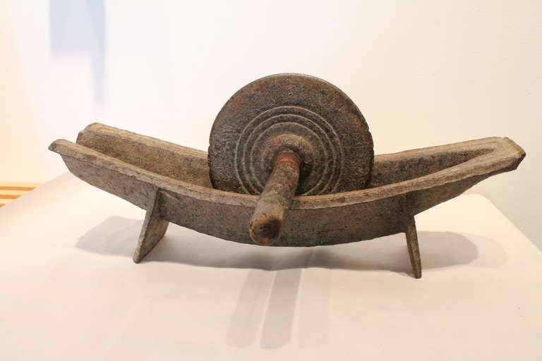 Very powerful and graceful proportion and line.
The bowl has a very simple raised line that follows the perimeter and the wheel has an elegant concentric circle design and a beautifully worn and heavily used wooden dowel handle.
Wonderful