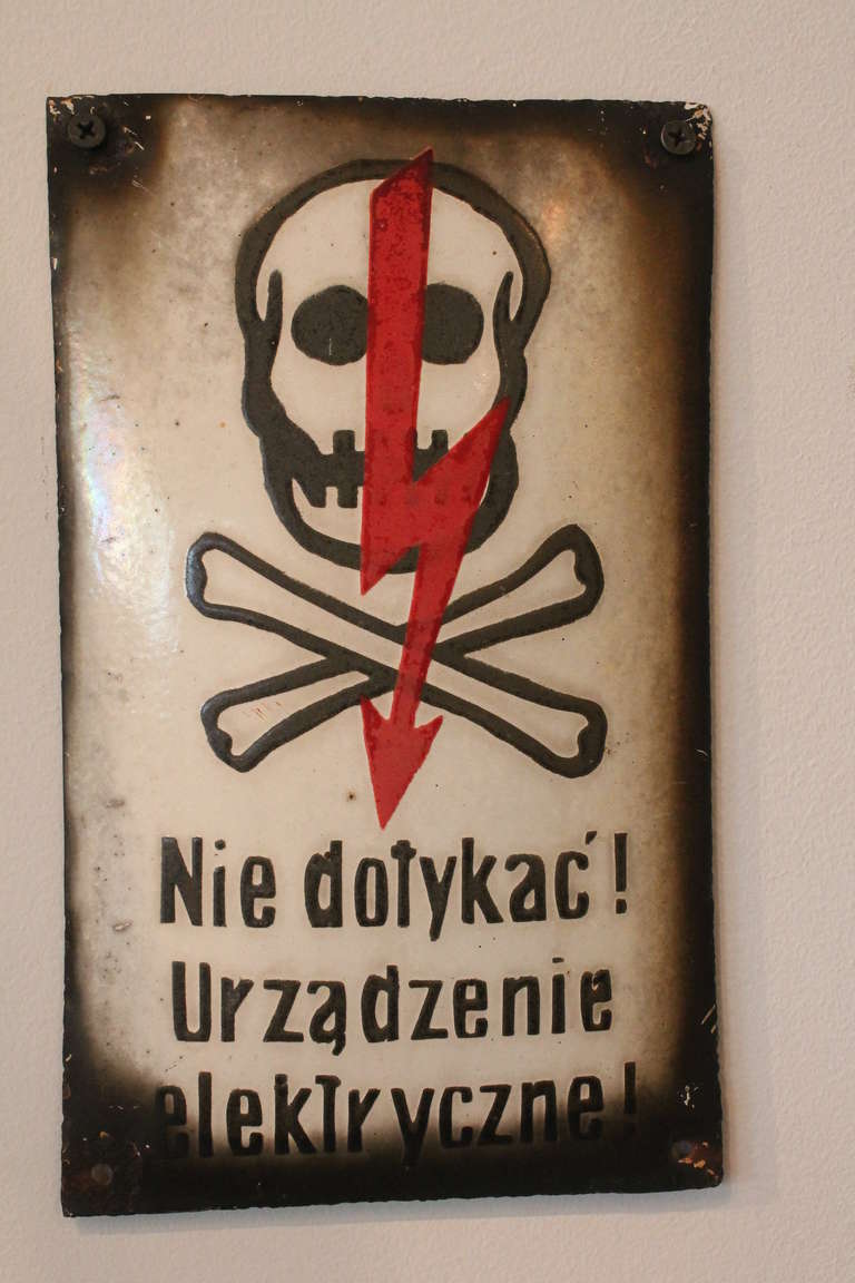 Polish skull and cross bones with vibrant red arrow enameled sign.
Great graphics and patina.